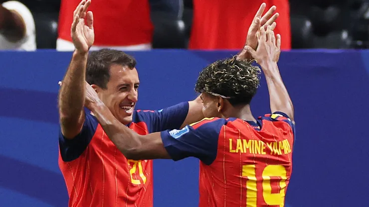 Mikel Oyarzabal #21 of Spain celebrates with teammate Lamine Yamal #19 after scoring.