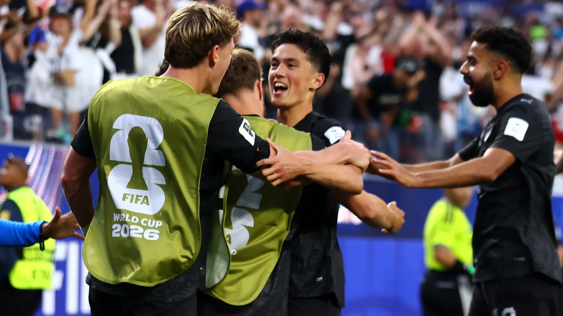 Elijah Just #11 of New Zealand celebrates with his teammates after scoring a goal.