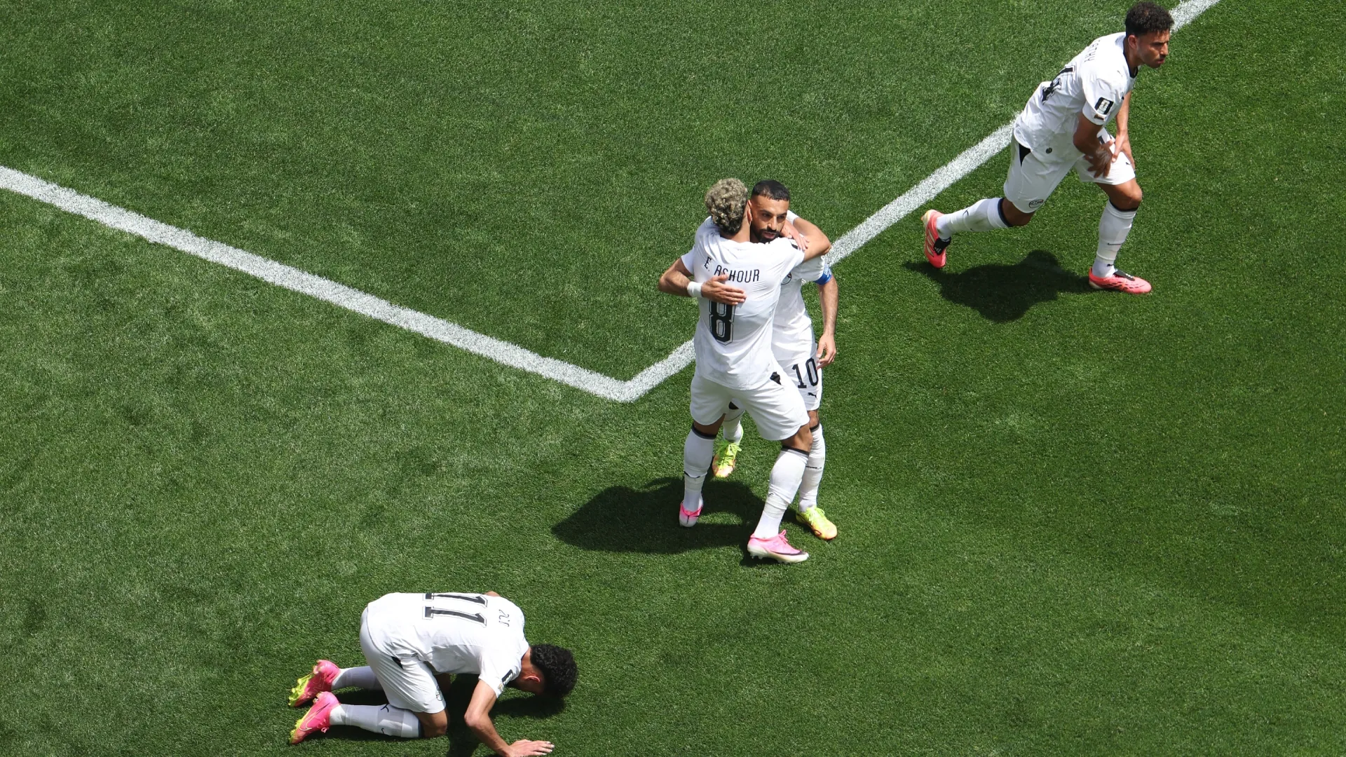 Emam Ashour #8 of Egypt celebrates with Mohamed Salah #10 after scoring.