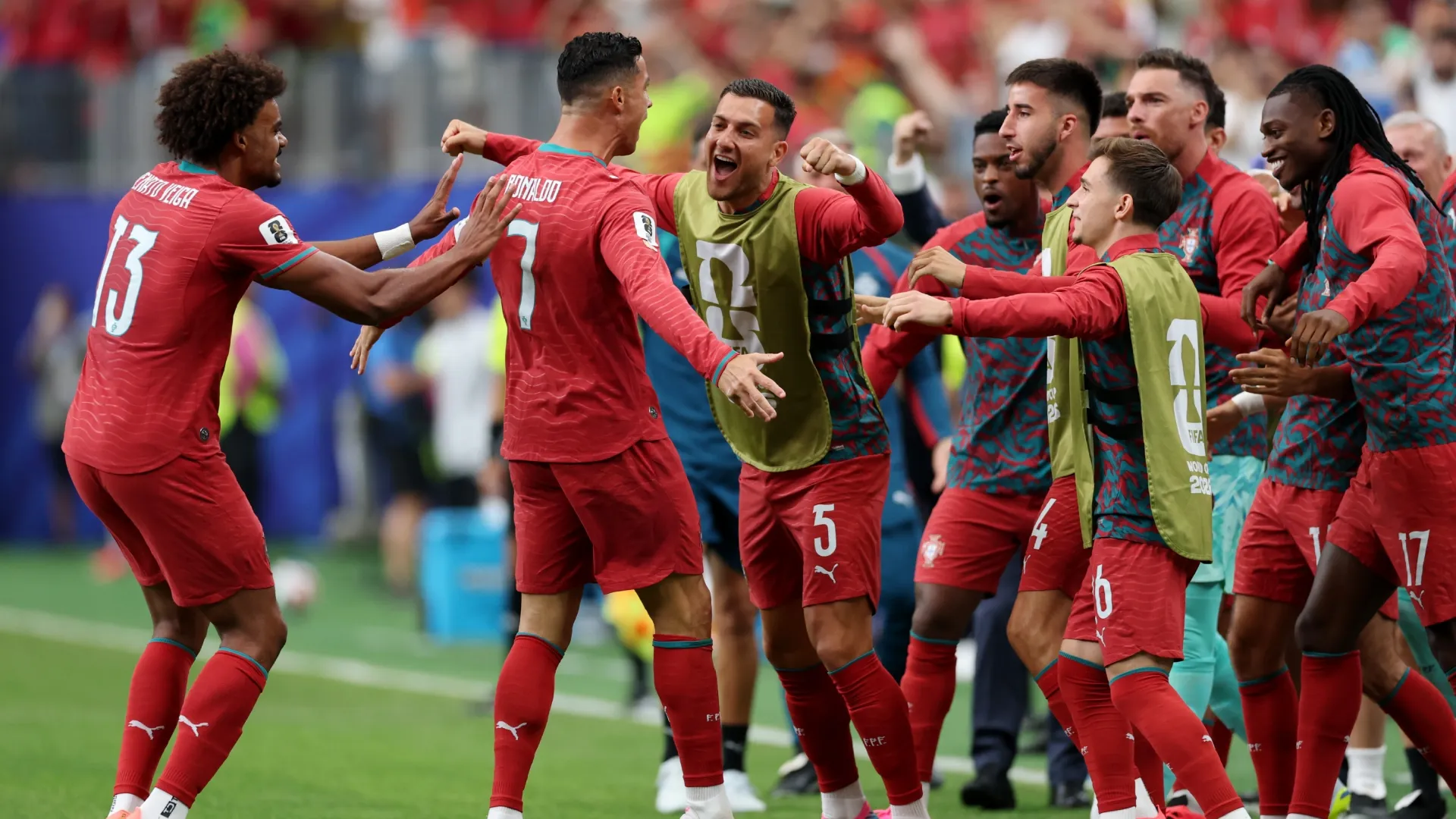 Cristiano Ronaldo #7 of Portugal celebrates with teammates after scoring.