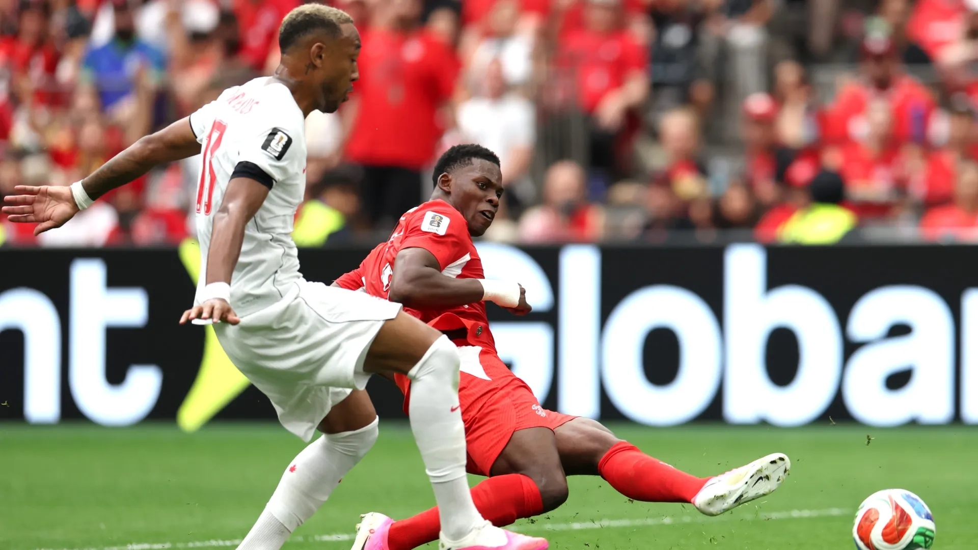Breel Embolo #7 of Switzerland shoots while Derek Cornelius #13 of Canada.