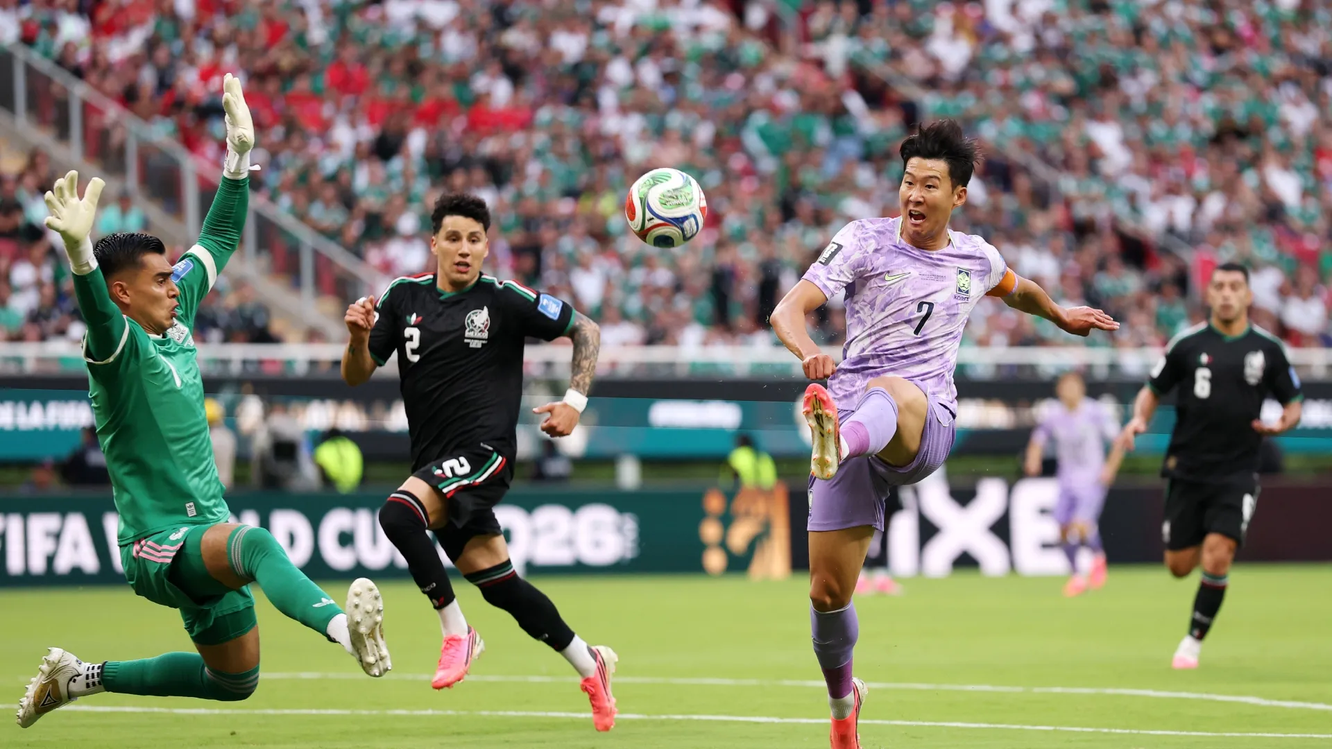 Heung-Min Son #7 of Korea Republic shoots while Raul Rangel #1 of Mexico attempts to save.