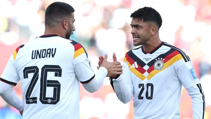 Deniz Undav #26 of Germany celebrates with teammate Nadiem Amiri #20.