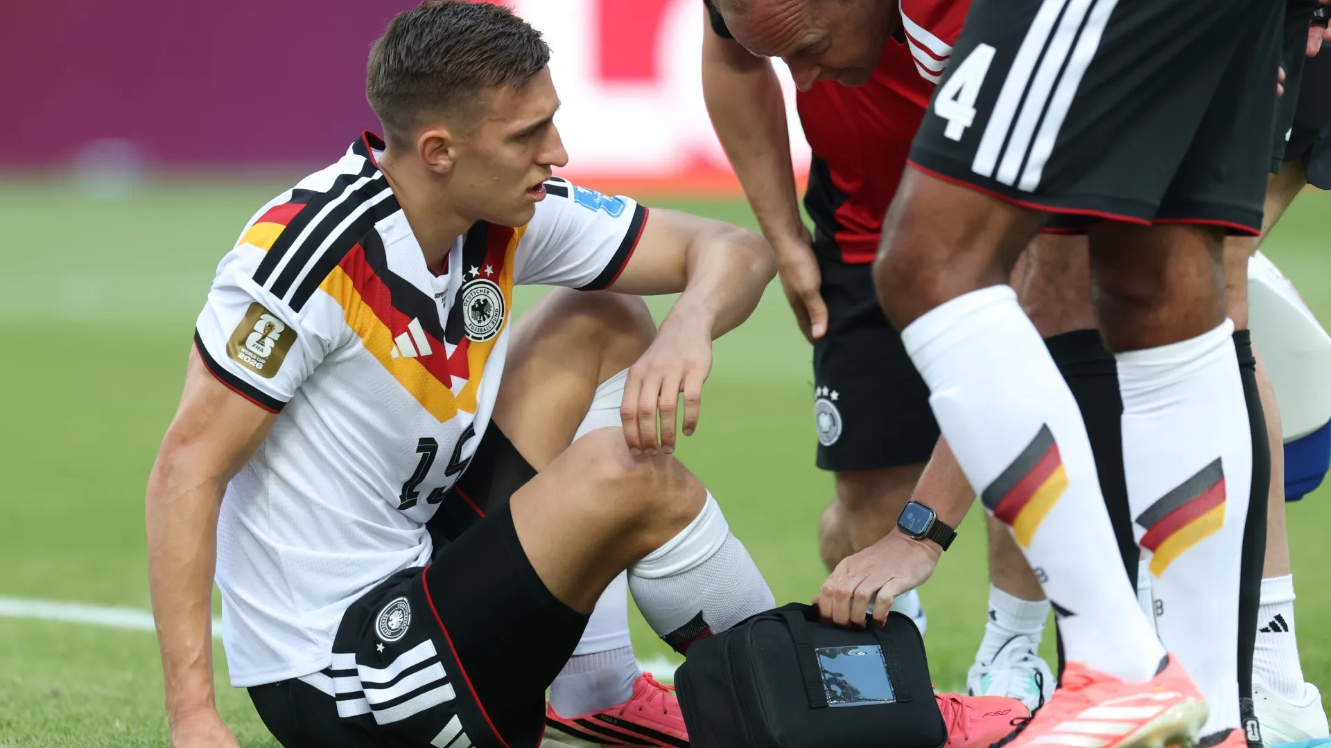 Nico Schlotterbeck #15 of Germany receives medical attention.