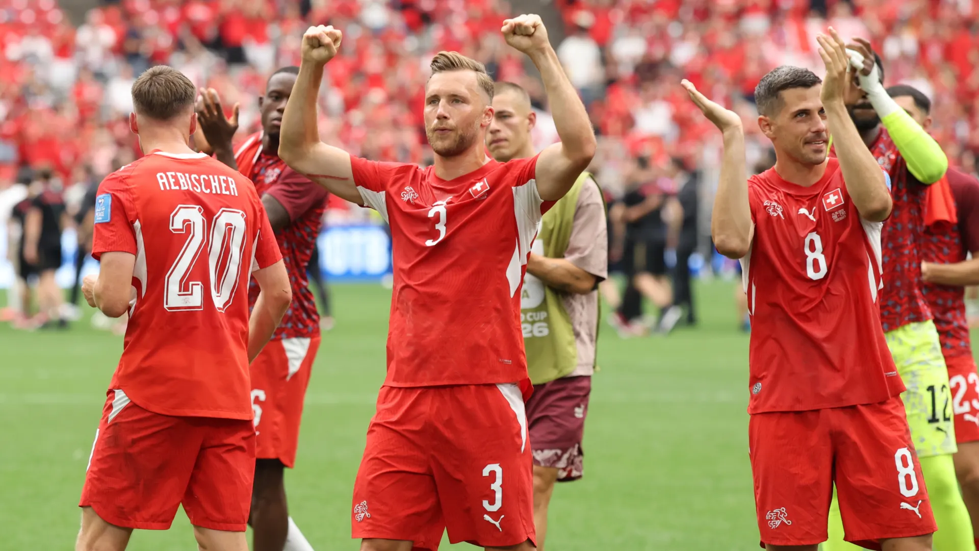 Silvan Widmer #3 and Remo Freuler #8 of Switzerland applaud fans