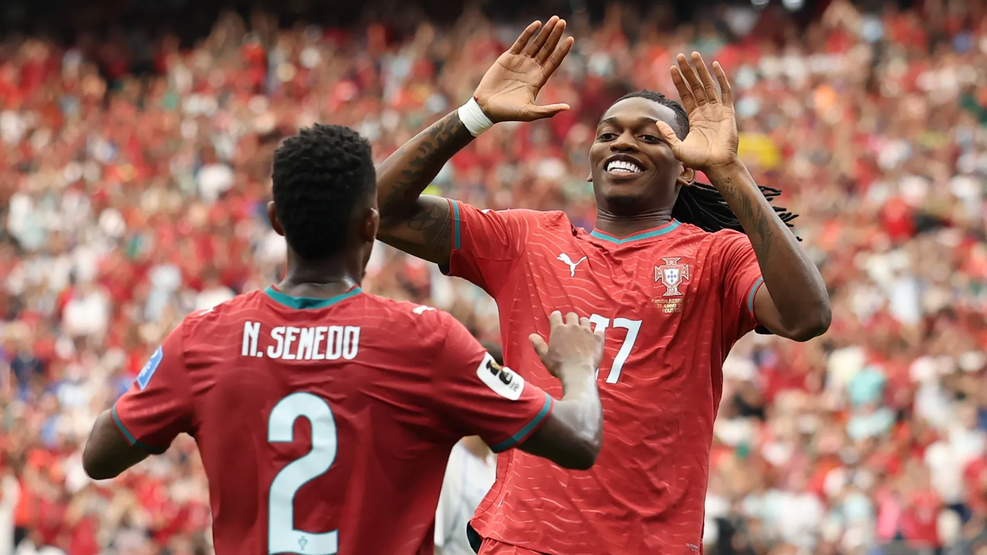 Rafael Leao #17 of Portugal celebrates with teammate Nelson Semedo #2 after scoring.