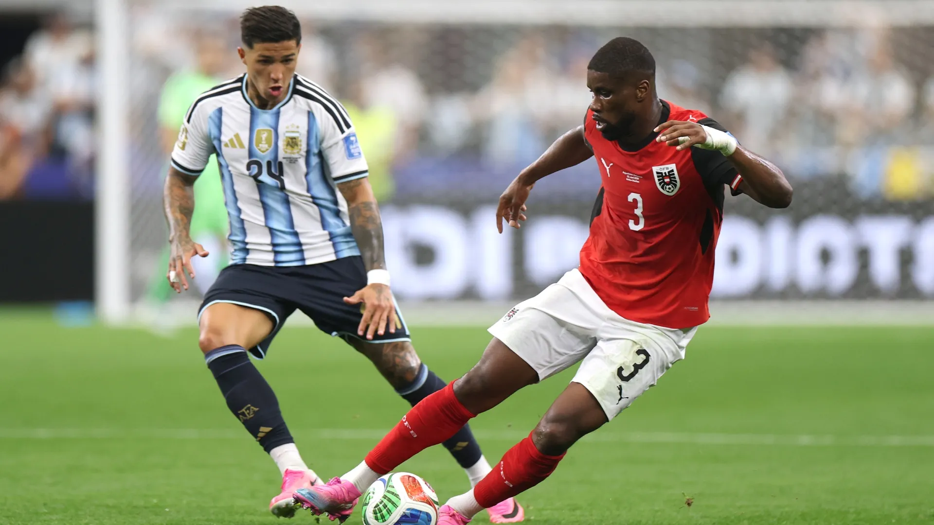 Kevin Danso #3 of Austria controls the ball against Enzo Fernandez #24 of Argentina.