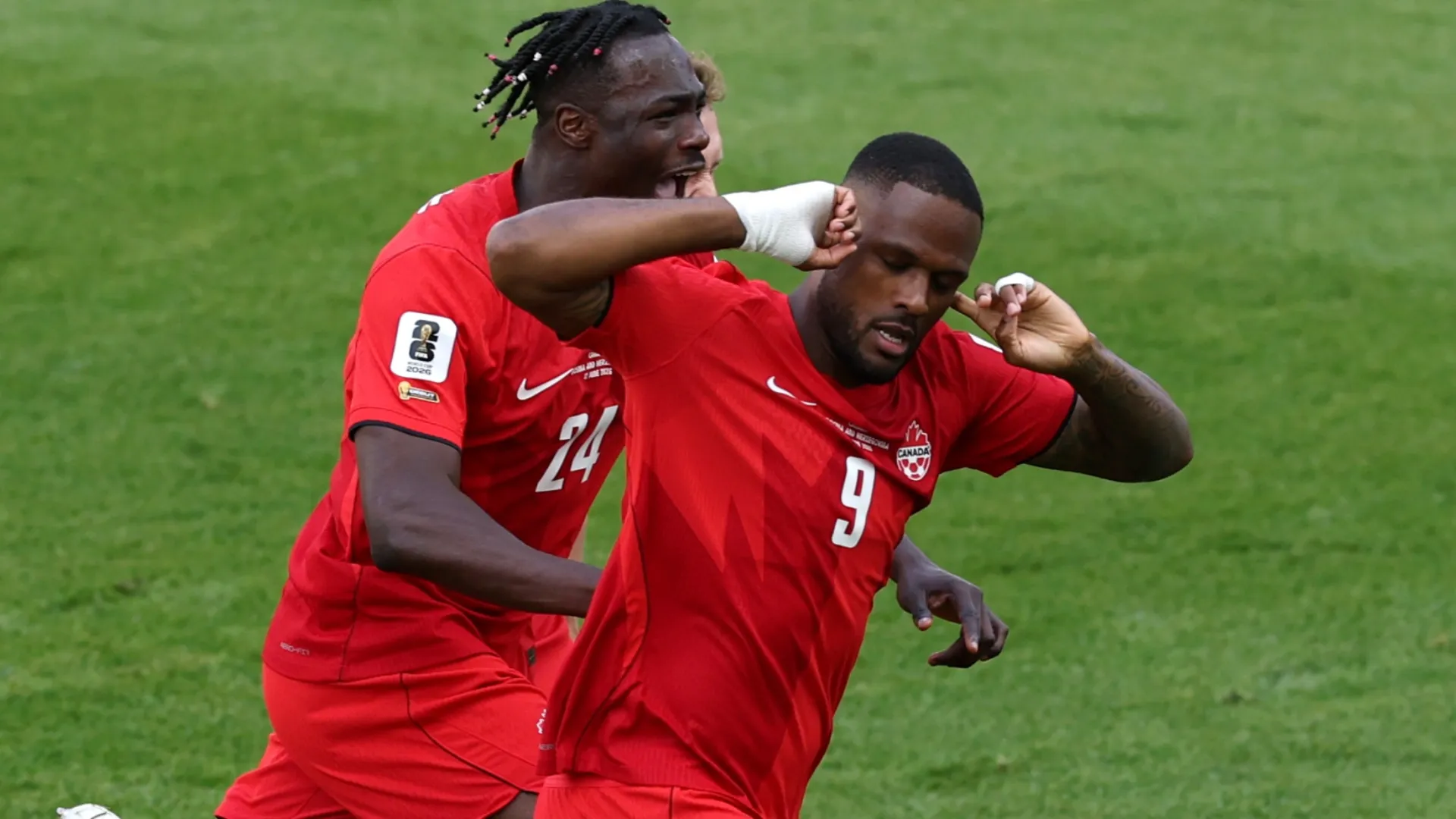 Cyle Larin #9 of Canada celebrates with Promise David #24 after scoring a goal.