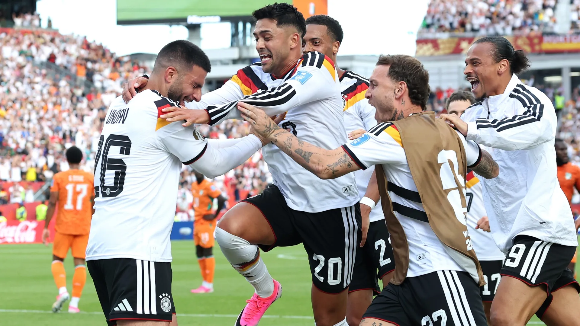 Deniz Undav (L) #26 of Germany celebrates with teammate Nadiem Amiri #20 and others after scoring.