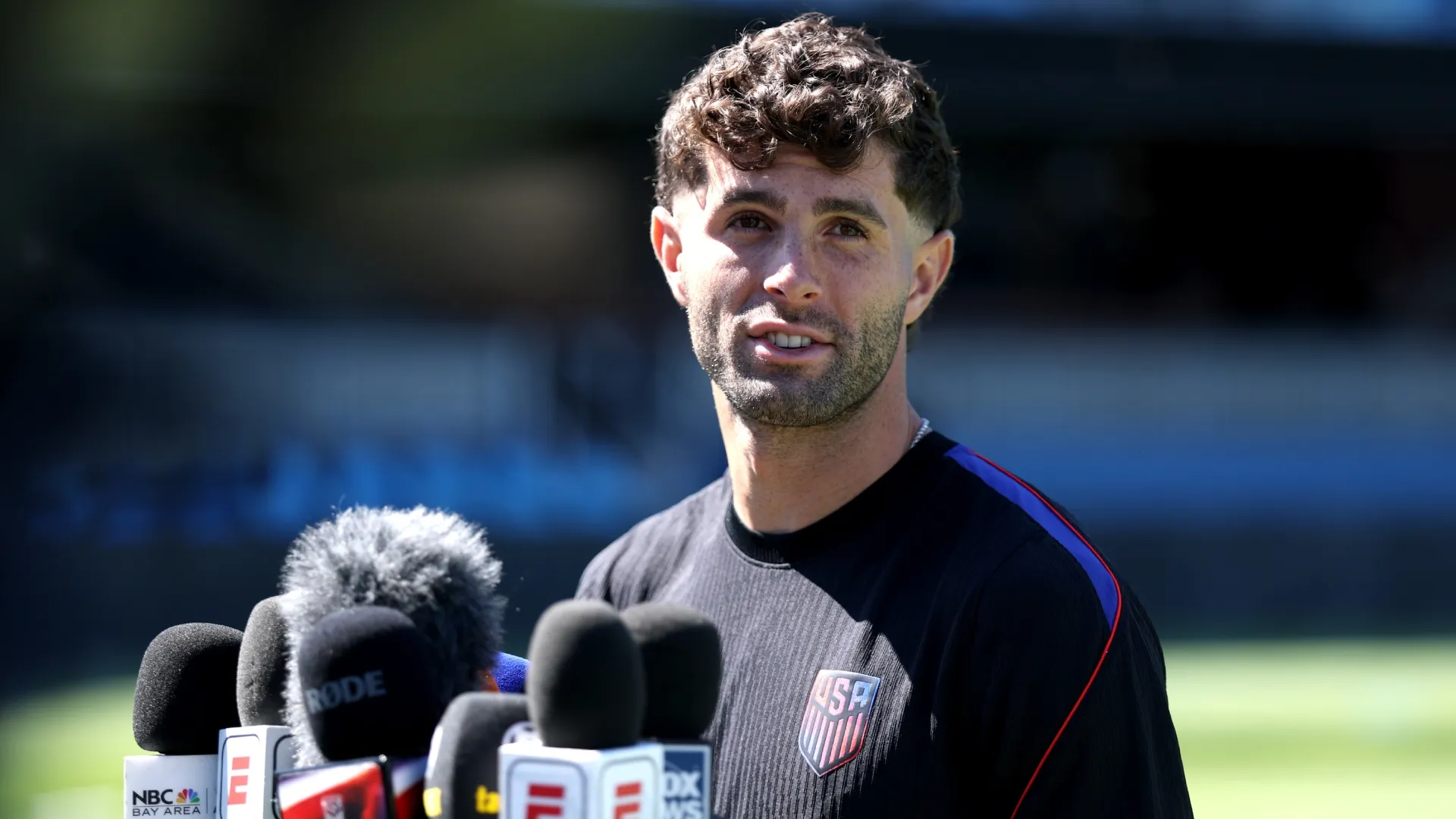 Christian Pulisic #10 of the United States fields questions from the media during the training session.