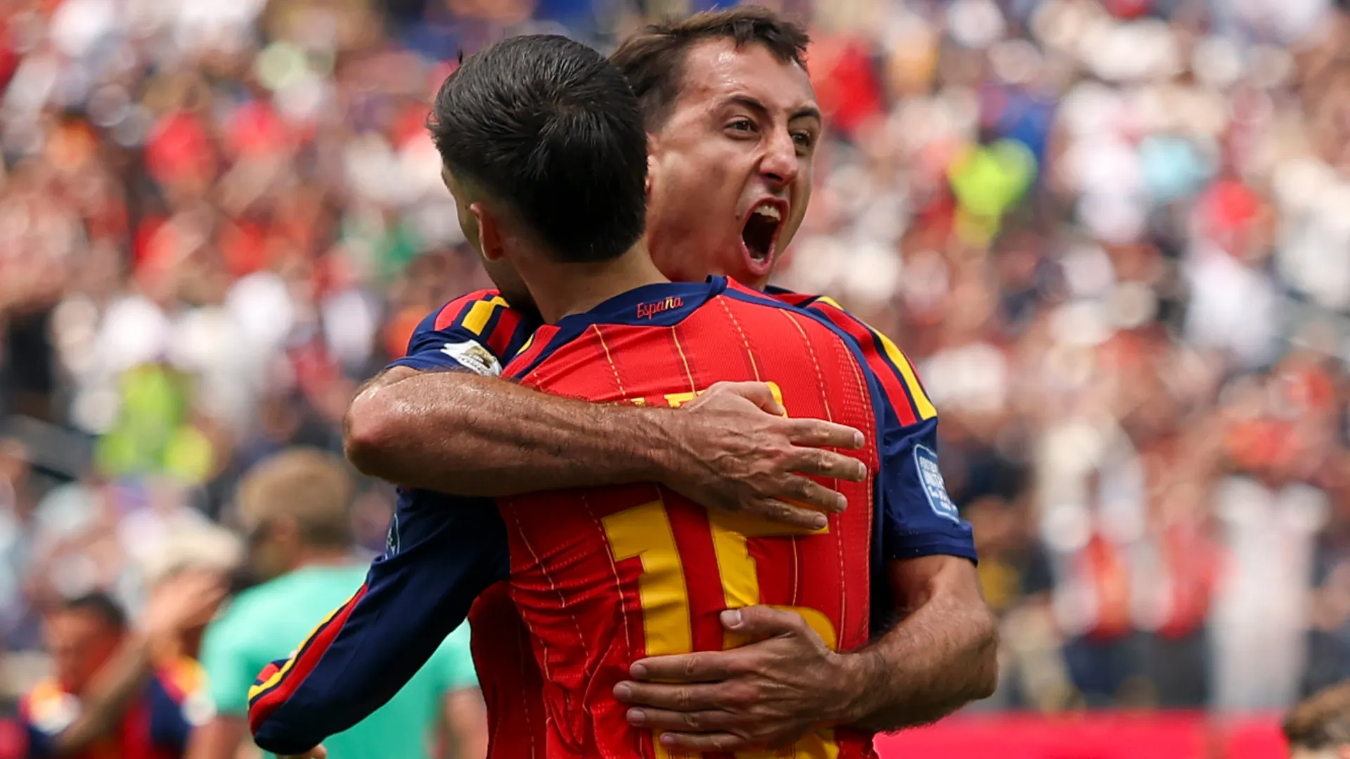 Mikel Oyarzabal #21 of Spain celebrates with Alex Baena #15 after scoring a goal.