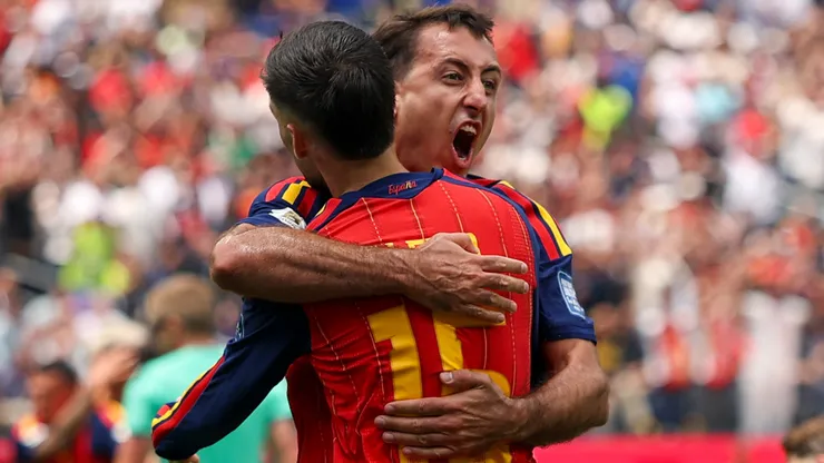 Mikel Oyarzabal #21 of Spain celebrates with Alex Baena #15 after scoring a goal.