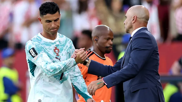 Roberto Martinez shakes hands with Cristiano Ronaldo #7 as he is substituted.