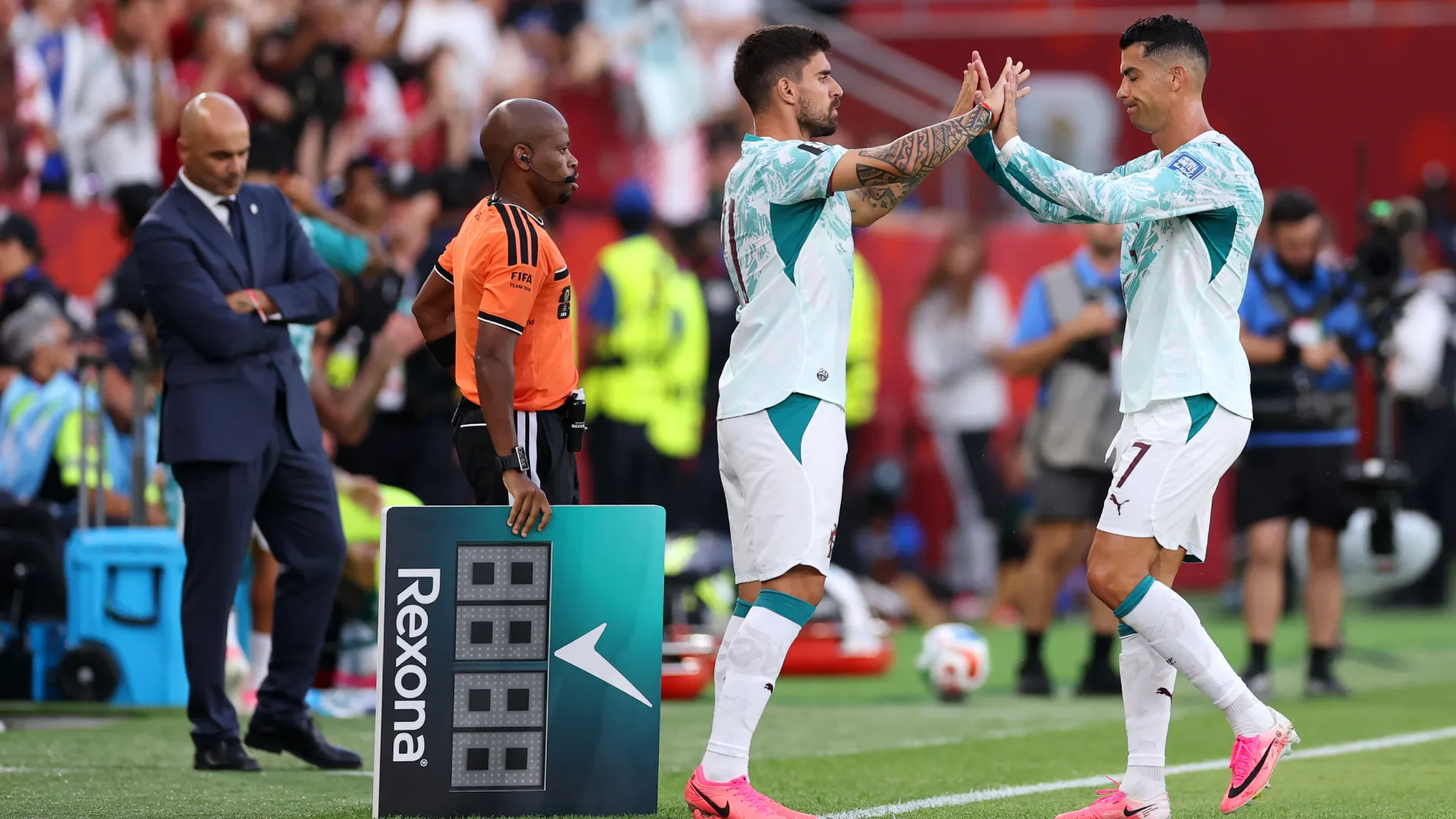 Cristiano Ronaldo #7 of Portugal high fives Ruben Neves #21 as he is substituted. (Getty Images)