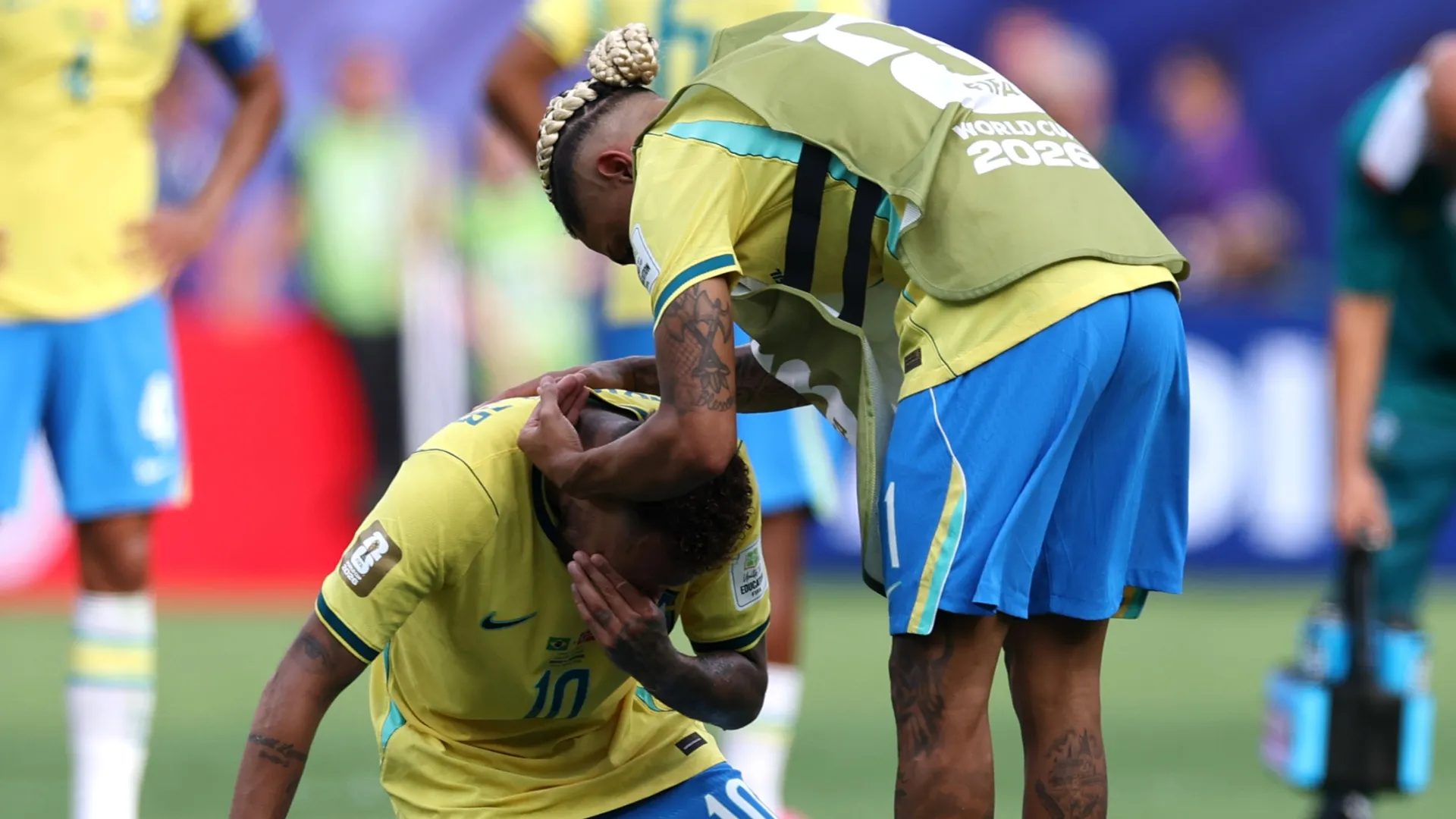 Neymar Jr #10 of Brazil is consoled by Raphinha #11.