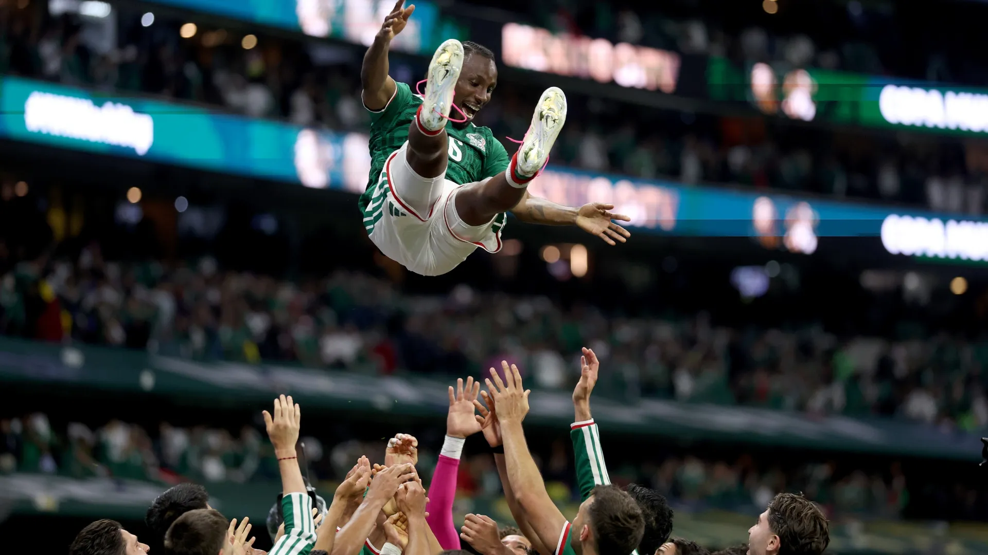 Julian Quinones #16 of Mexico is thrown in the air by his teammates.