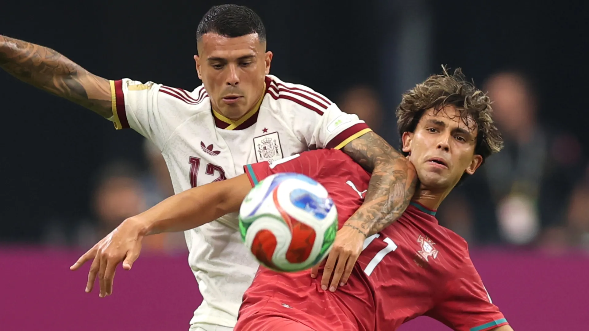 Joao Felix #11 of Portugal competes for the ball against Pedro Porro #12 of Spain.