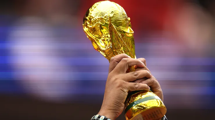 A fan holds a replica of the FIFA World Cup Trophy.
