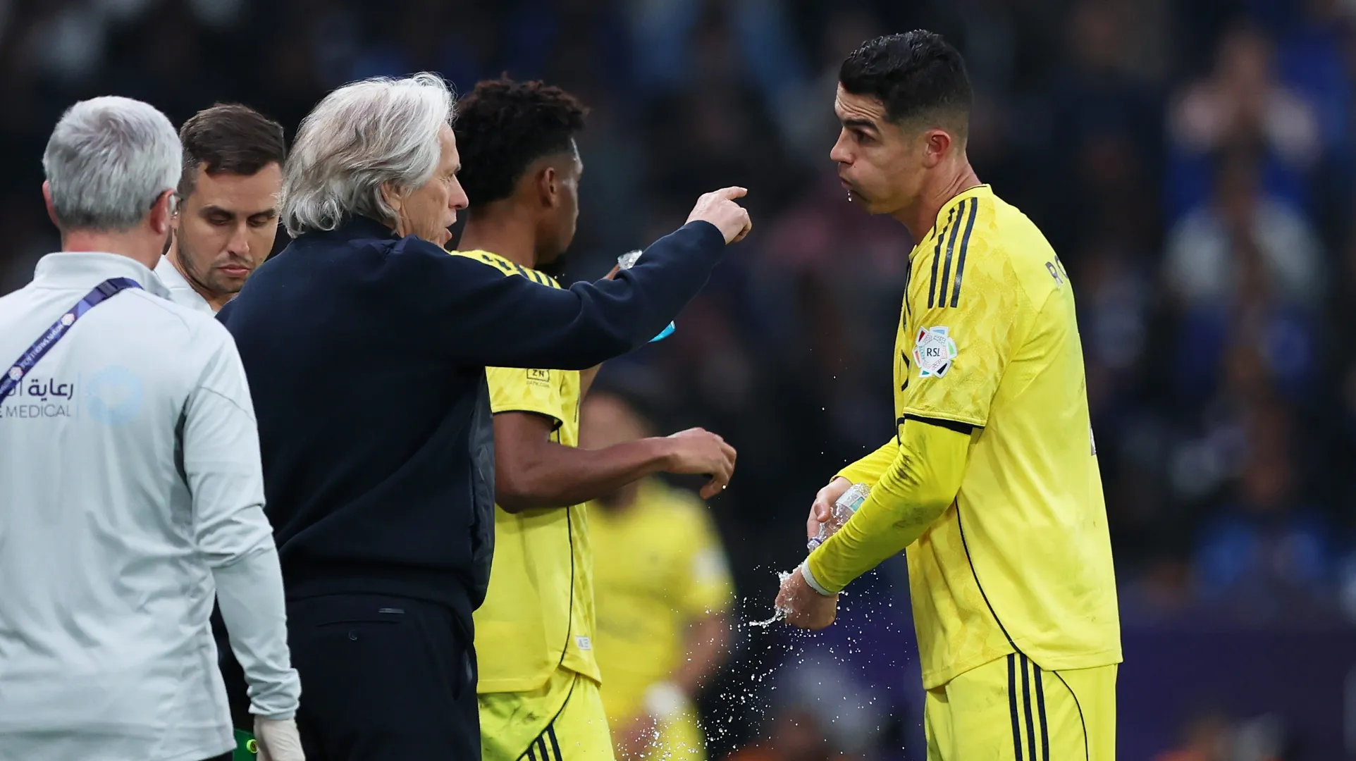 Head coach Jorge Jesus interacts with Cristiano Ronaldo of Al Nassr.