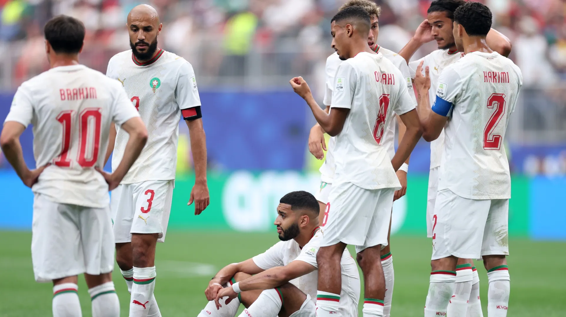 Ismael Saibari #11 (C) of Morocco reacts after sustaining an injury against Canada.