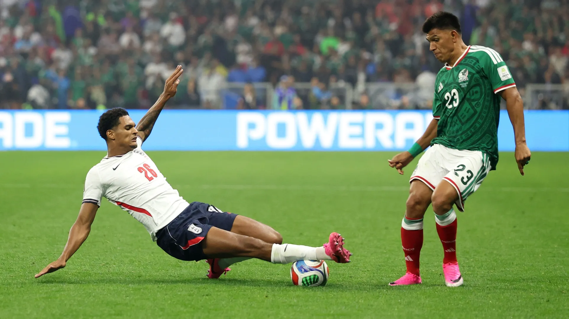 Jesus Gallardo #23 of Mexico is tackled by Jarell Quansah #26 of England.