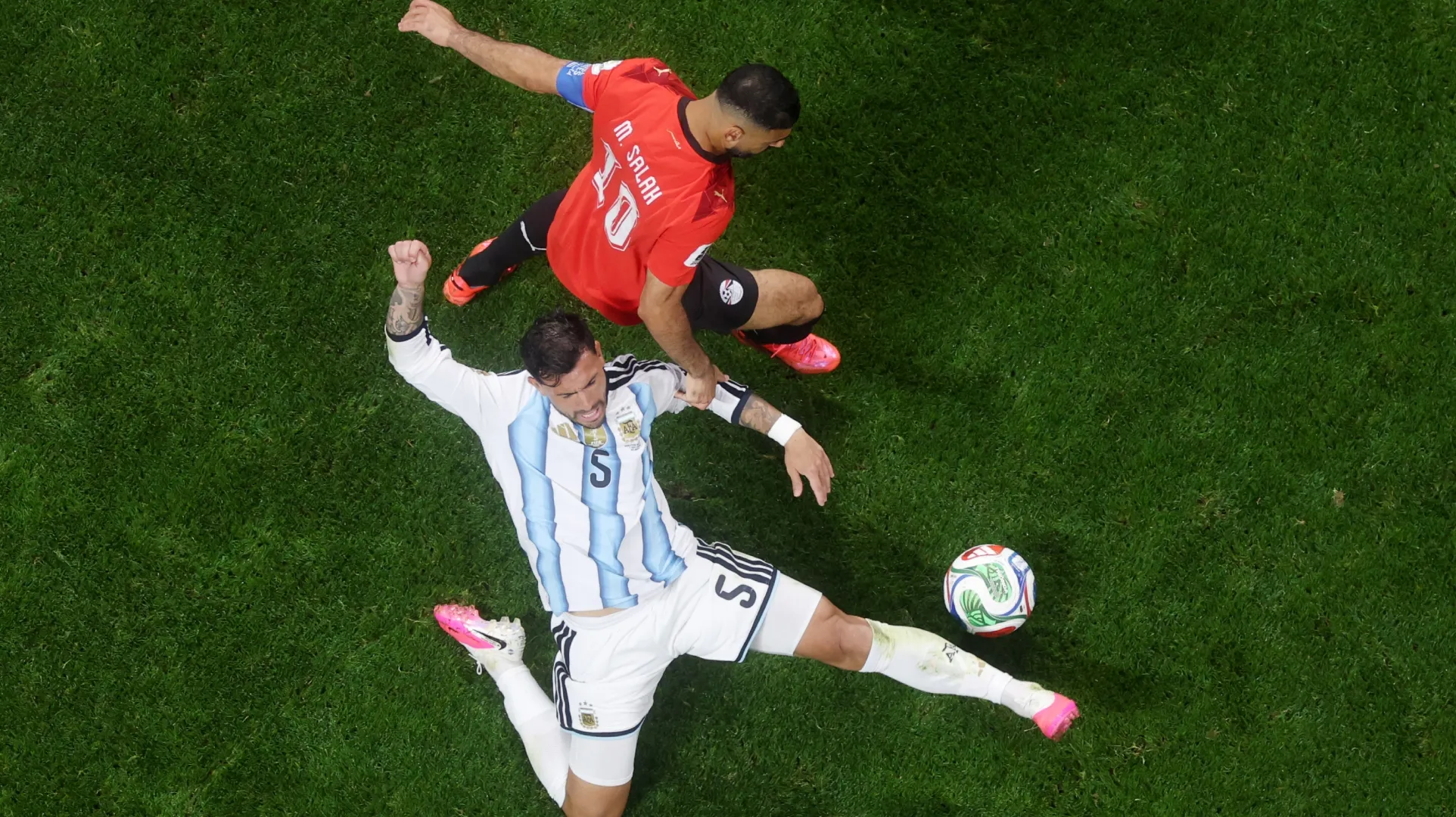 Leandro Paredes #5 of Argentina and Mohamed Salah #10 of Egypt compete for the ball.