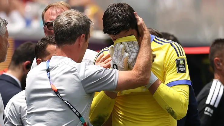 Thibaut Courtois #1 of Belgium reacts with medical staff after being substituted.