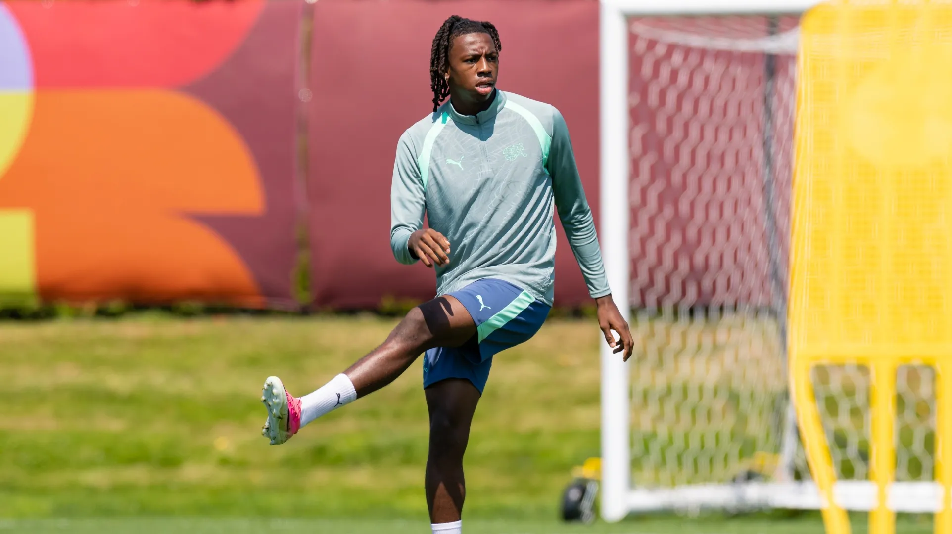 Manzambi Johan #9 of Switzerland stretches during a training session.