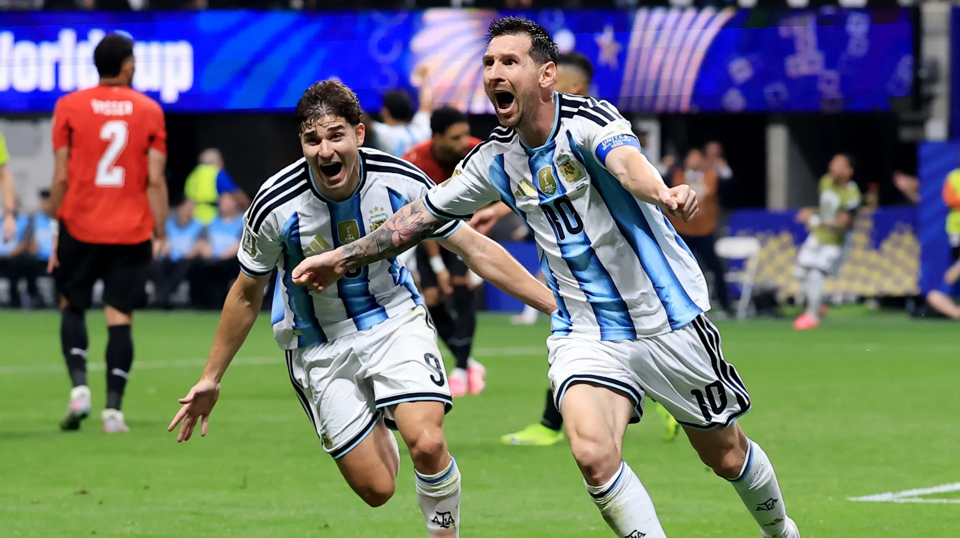 Lionel Messi #10 of Argentina celebrates with Julian Alvarez #9 after scoring against Egypt.
