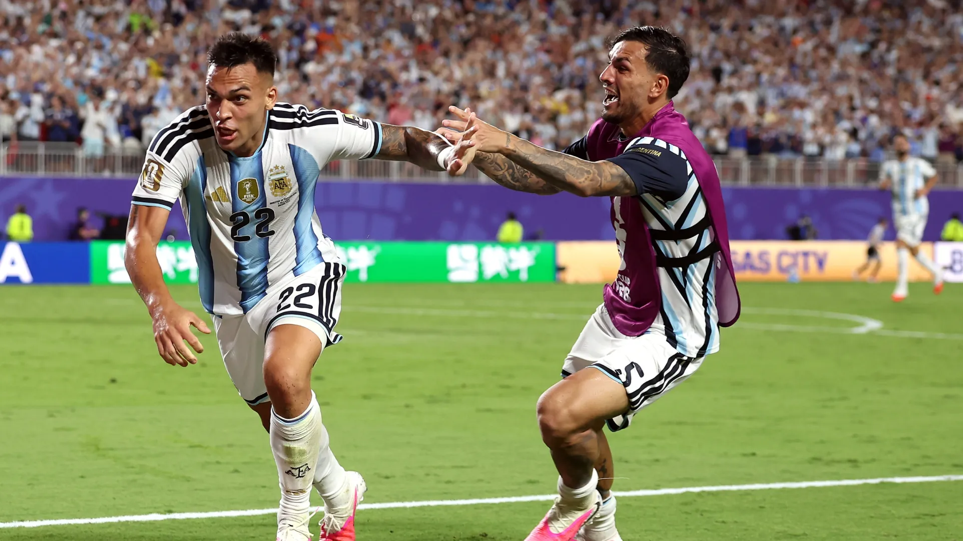 Lautaro Martinez #22 of Argentina celebrates with Leandro Paredes #5 after scoring.
