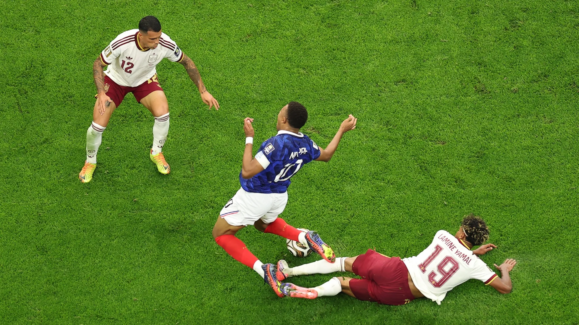 Kylian Mbappe #10 of France competes for the ball against Lamine Yamal #19 and Pedro Porro #12 of Spain.