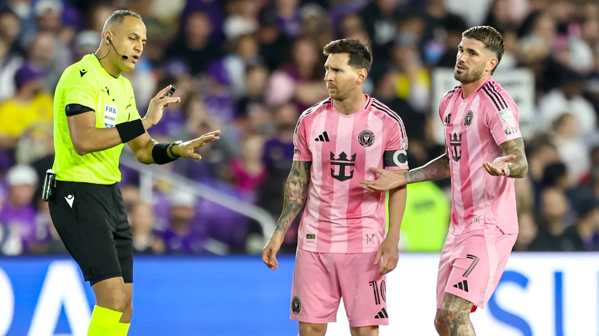 Rodrigo de Paul #7 and Lionel Messi #10 of Inter Miami talk with referee Ismail Elfath.