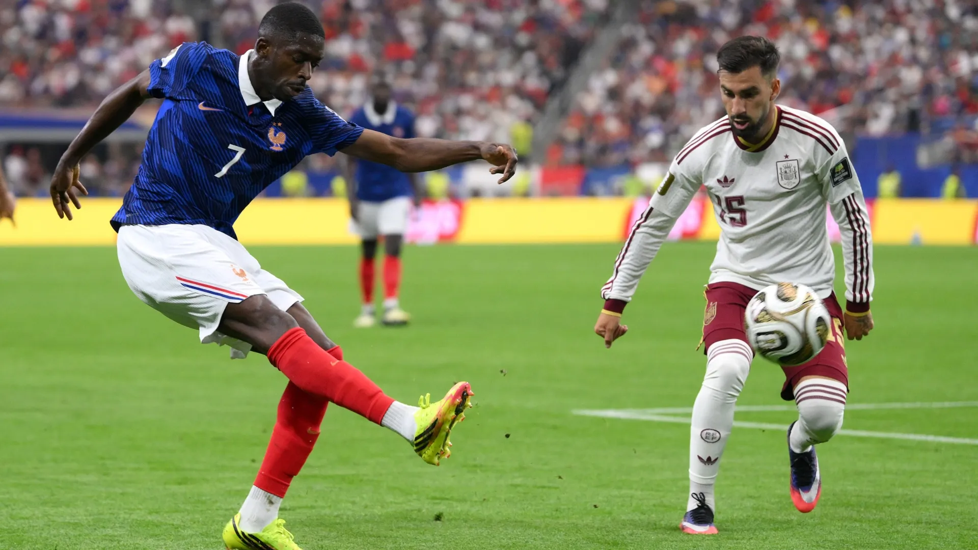 Ousmane Dembele #7 of France crosses the ball against Alex Baena #15 of Spain.