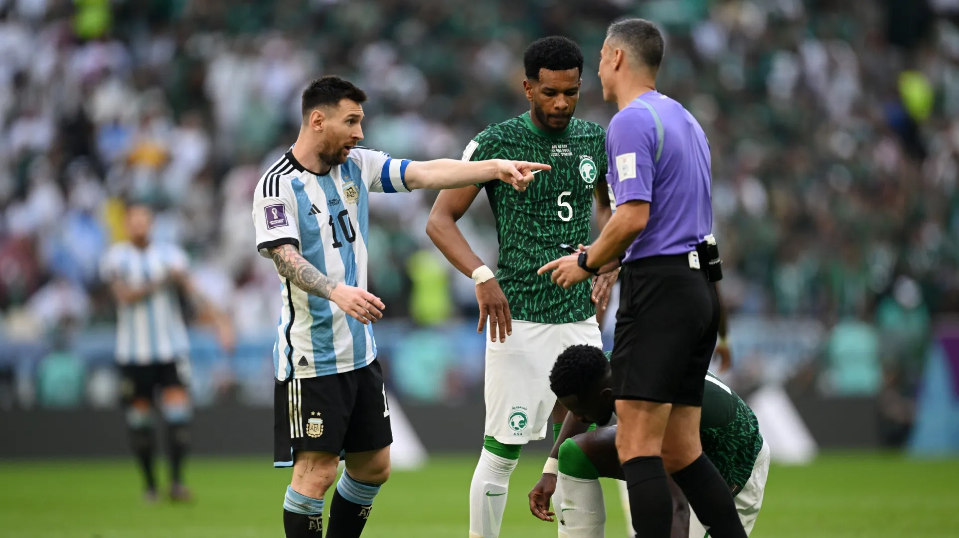 Lionel Messi of Argentina speaks with referee Slavko Vincic.