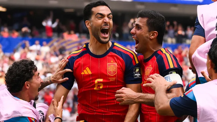 Mikel Merino #6 of Spain celebrates with his teammates scoring a goal.