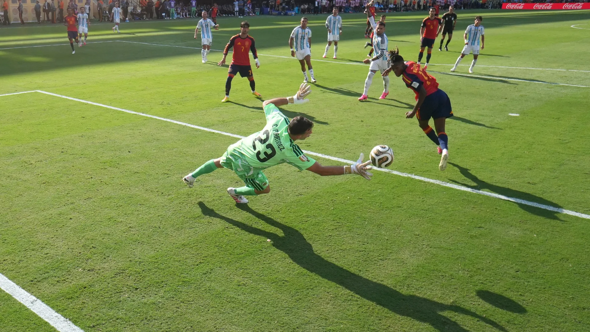 Nico Williams #17 of Spain heads the ball saved by Emiliano Martinez #23 of Argentina.