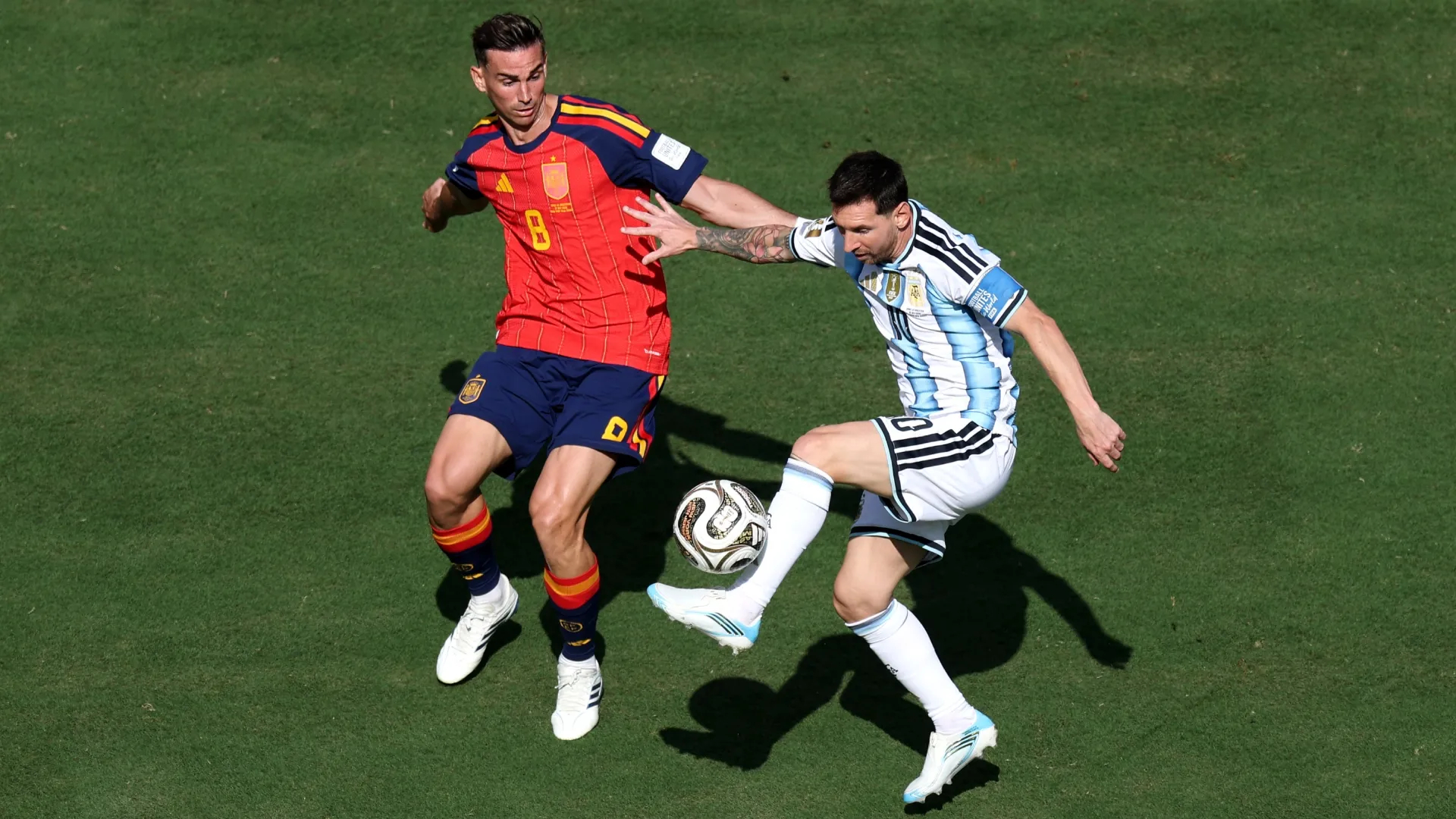 Lionel Messi #10 of Argentina competes for the ball against Fabian Ruiz #8 of Spain.