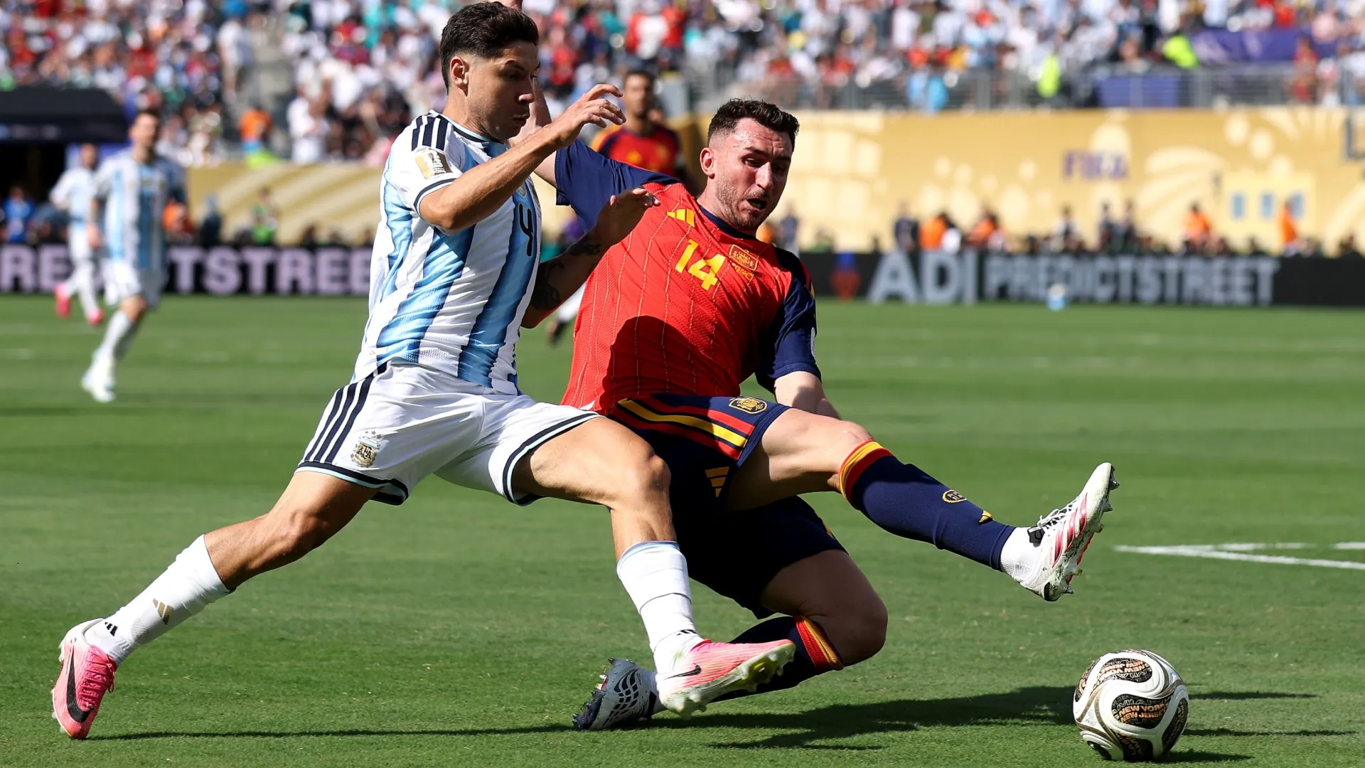 Gonzalo Montiel #4 of Argentina competes for the ball against Aymeric Laporte #14 of Spain.