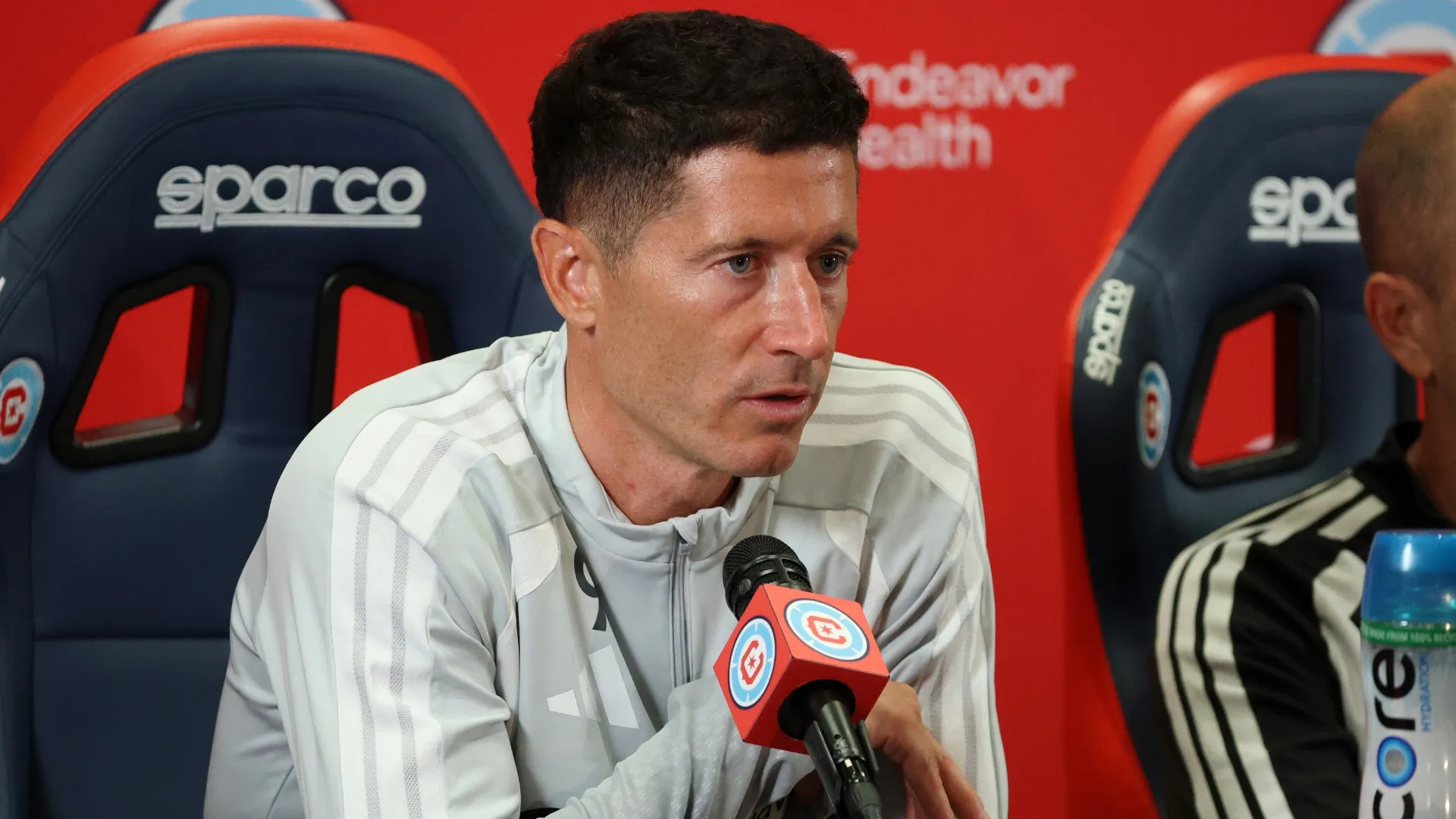 Robert Lewandowski #9 speaks to the media during a press conference.