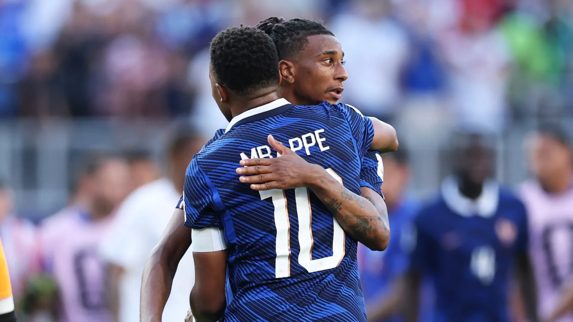 Kylian Mbappe #10 and Michael Olise #11 of France celebrate after the 1-0 victory over Paraguay.