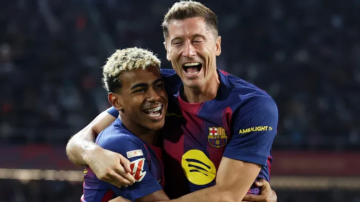 Robert Lewandowski of FC Barcelona celebrates scoring a goal with teammate Lamine Yamal.
