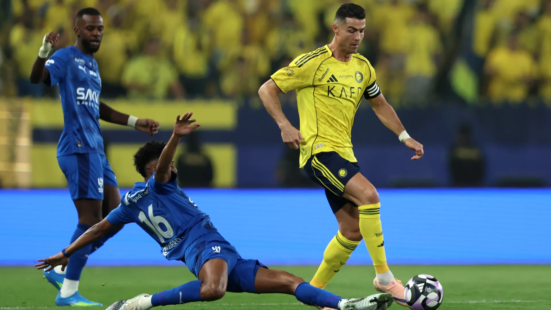 Cristiano Ronaldo of Al Nassr is challenged by Nasser Al-Dawsari of Al Hilal.