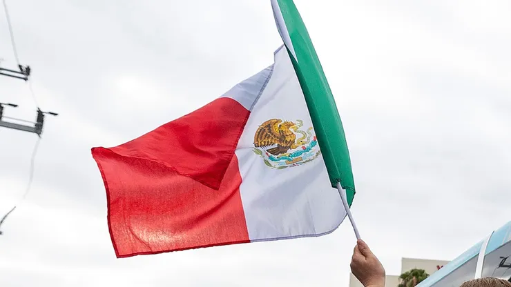 A Mexican fan holds a flag