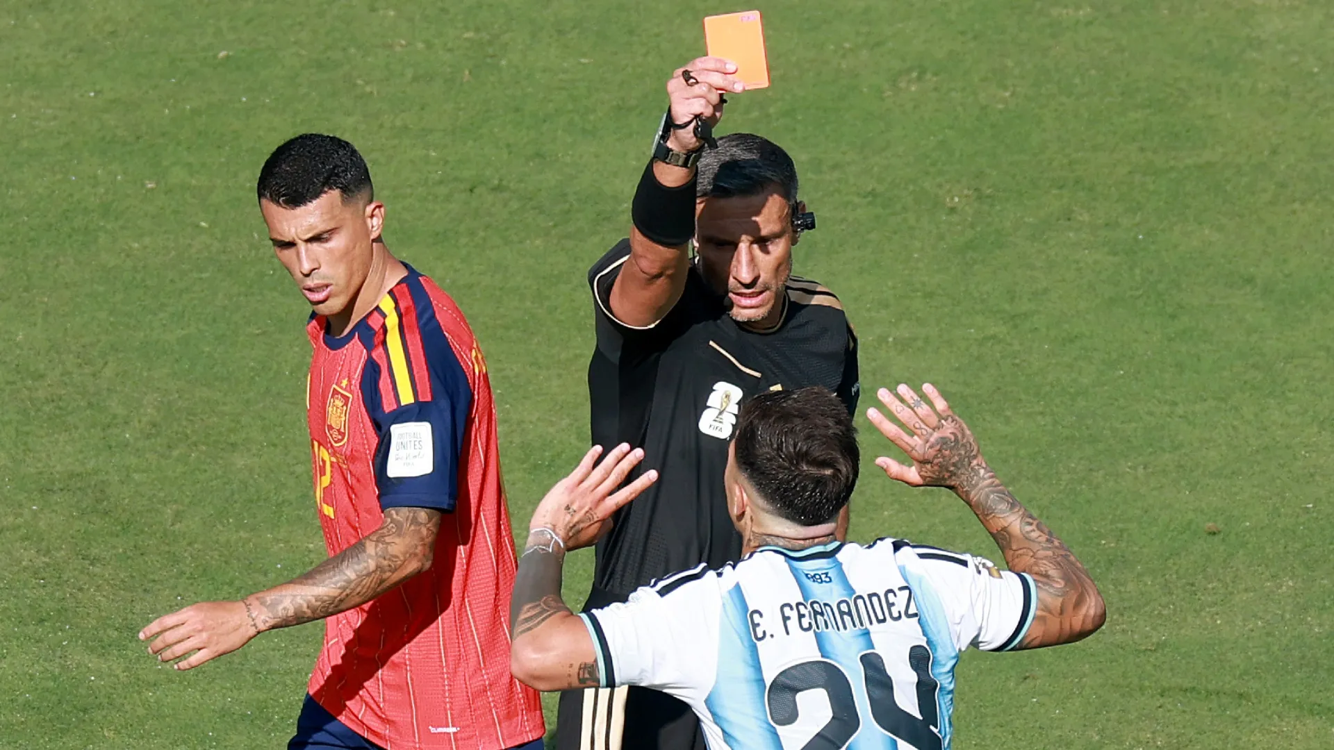 Referee Slavko Vincic shows a red card to Enzo Fernandez #24 of Argentina.
