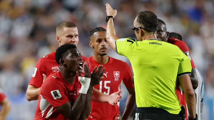 Breel Embolo #7 of Switzerland argues with referee Joao Pinheiro following his second yellow card vs Argentina.