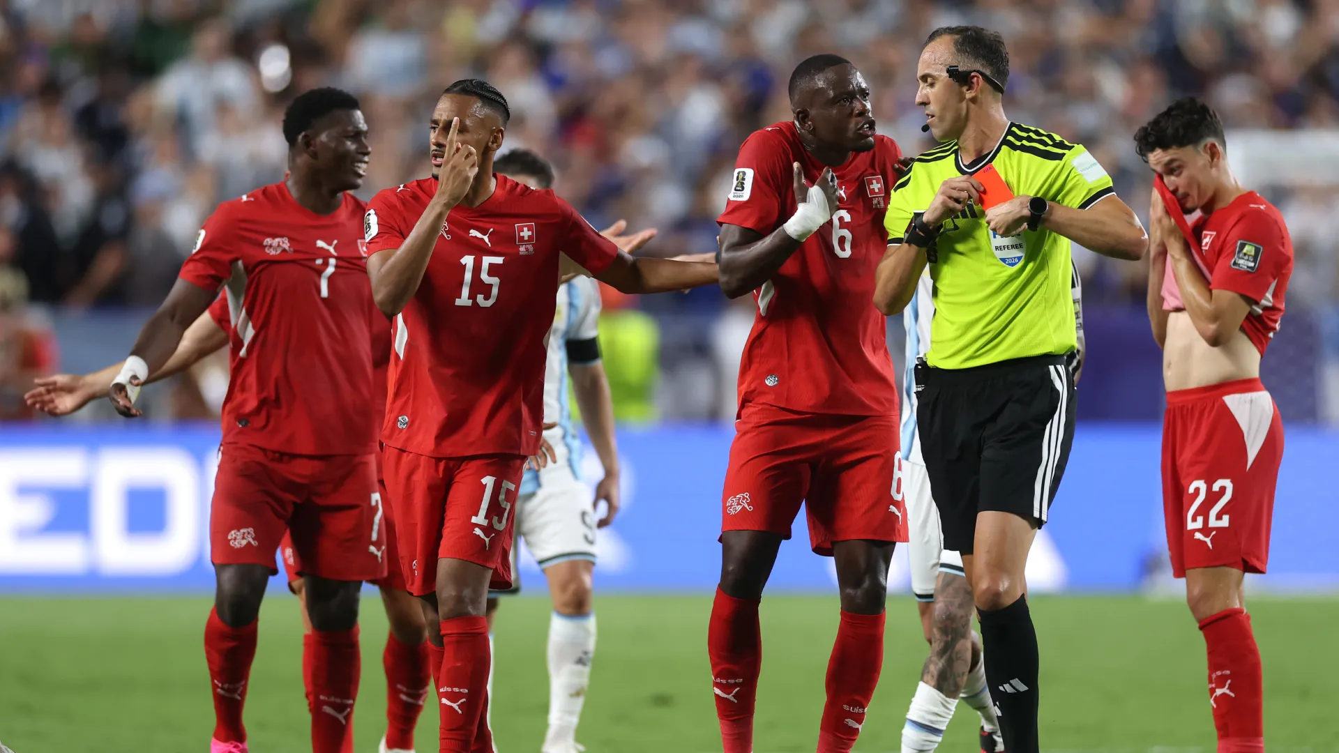 Referee Joao Pinheiro shows a red card to Breel Embolo #7 of Switzerland. (Getty Images)