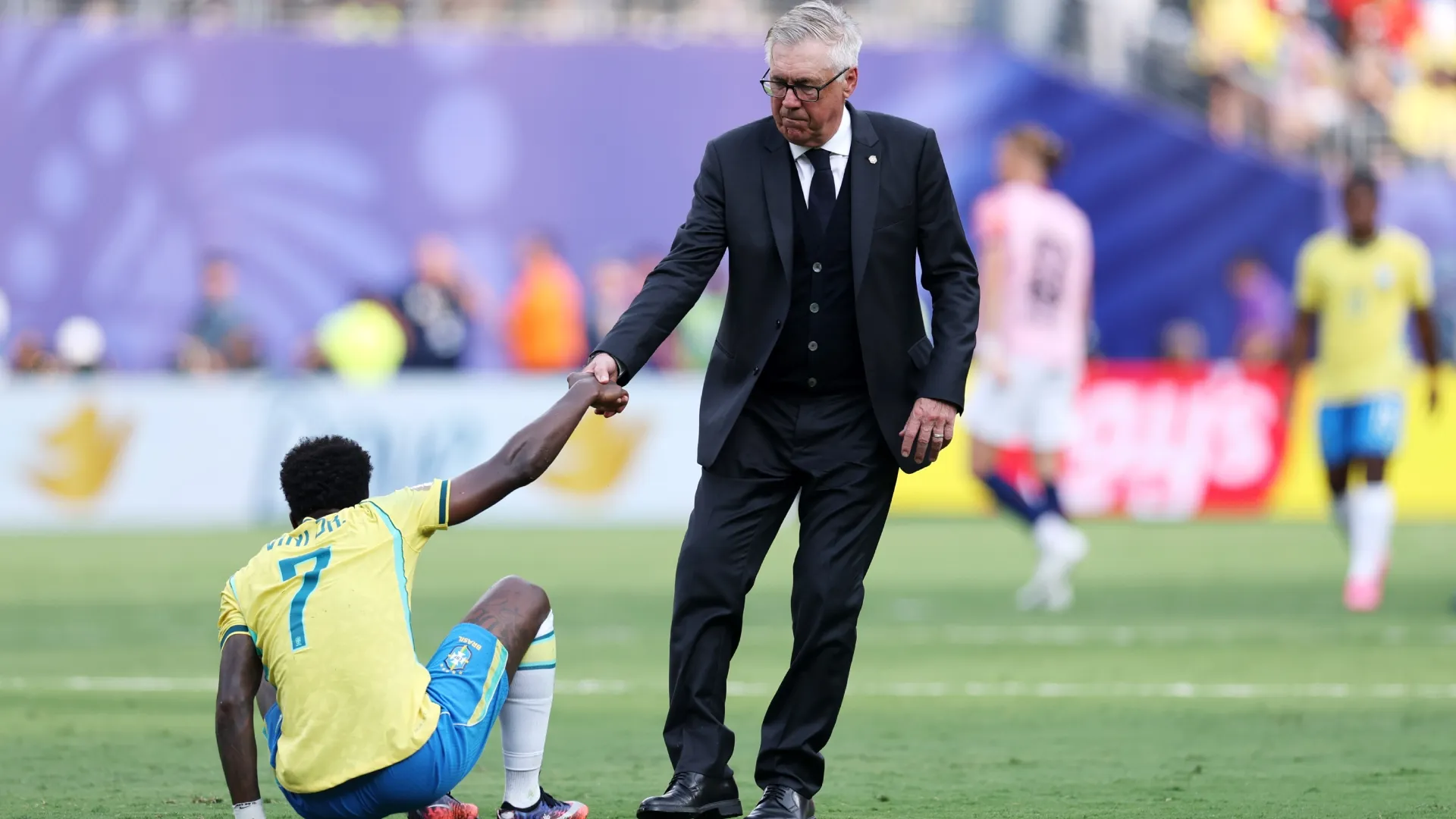 Vinicius Junior #7 is consoled by Carlo Ancelotti, Head Coach of Brazil.