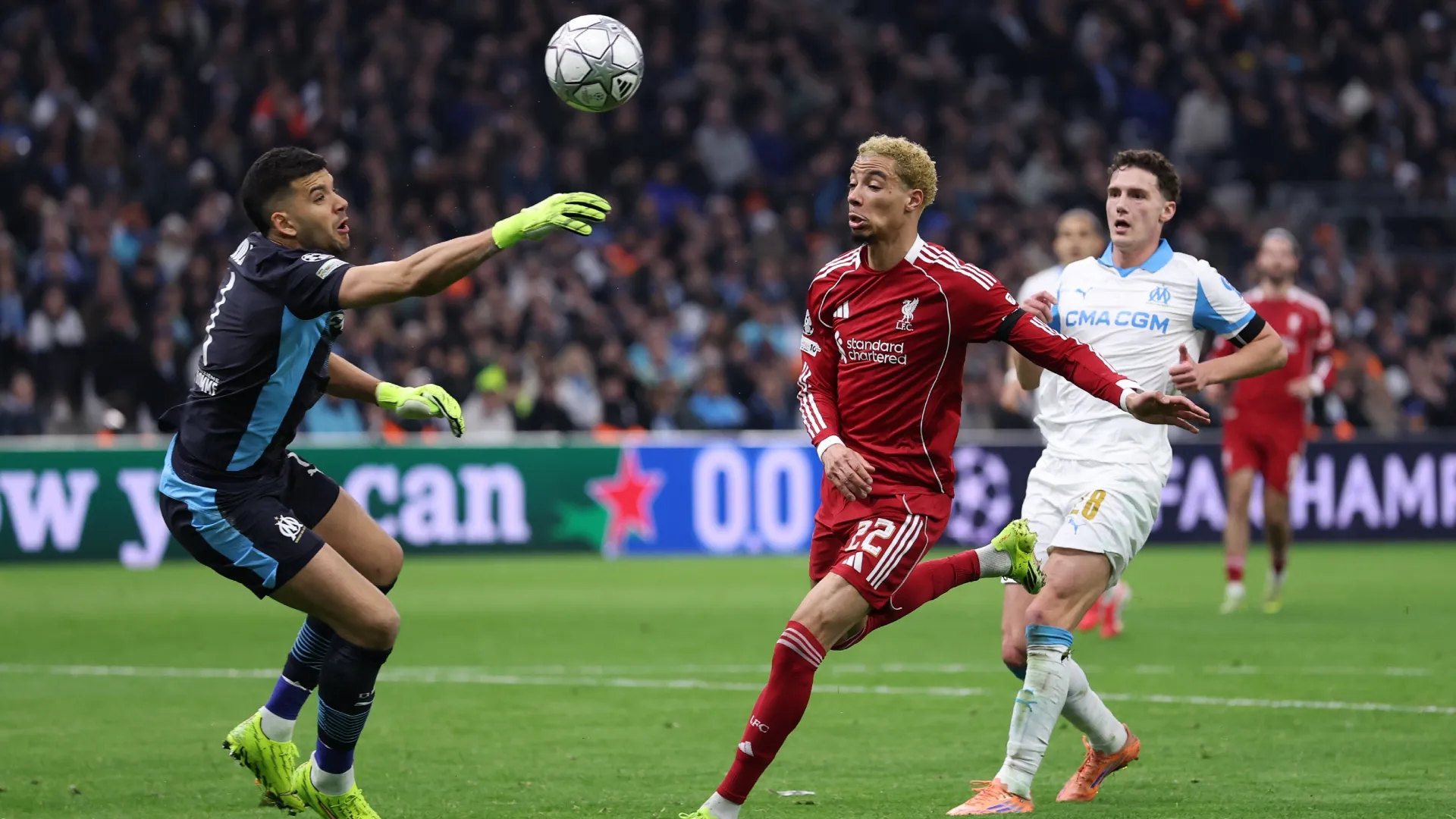 Hugo Ekitike of Liverpool battles for possession with Geronimo Rulli of Marseille.