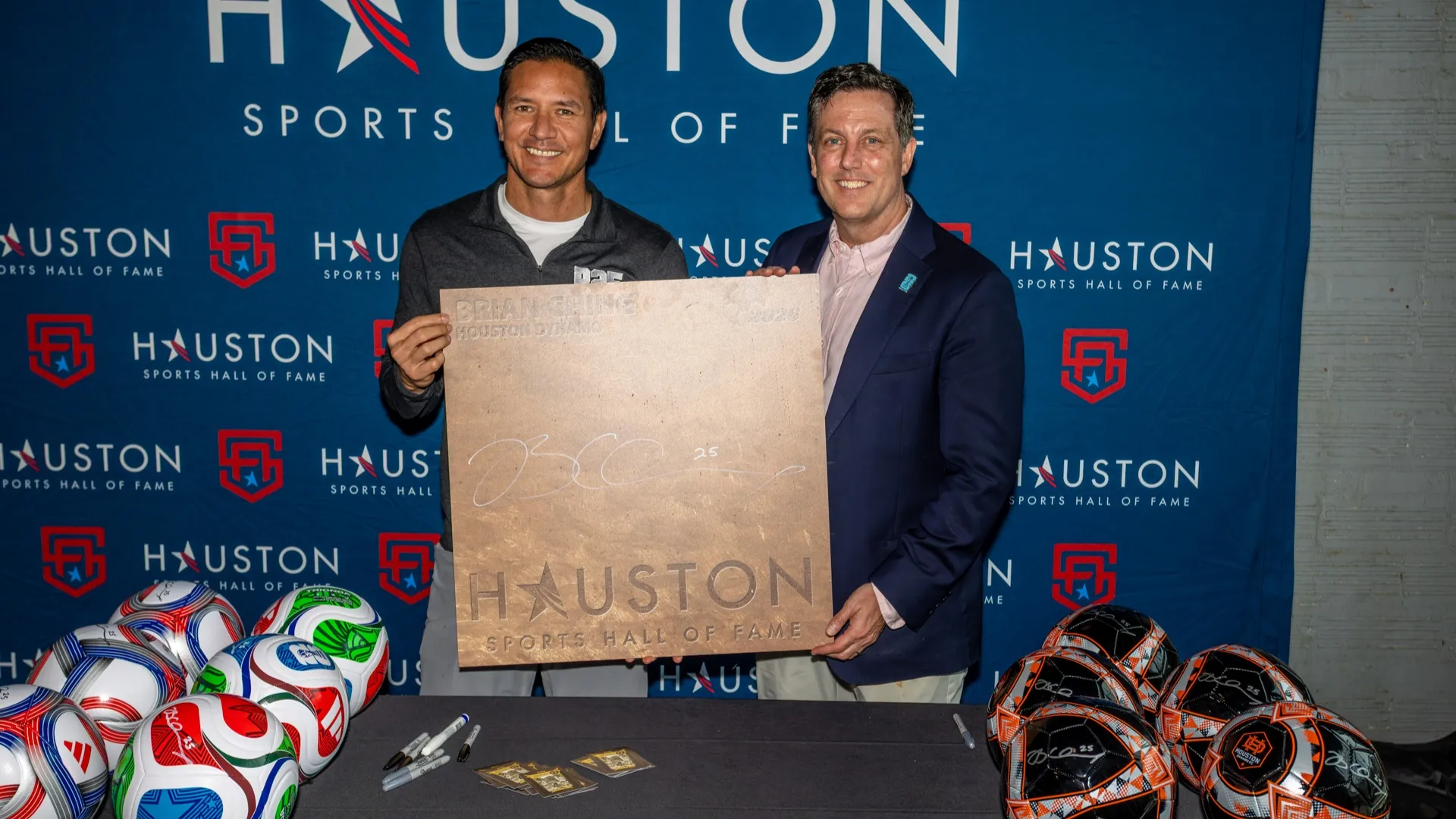 Chris Canetti (R) greets former Houston Dynamo Brian Ching (L) in Houston Sports Hall of Fame.