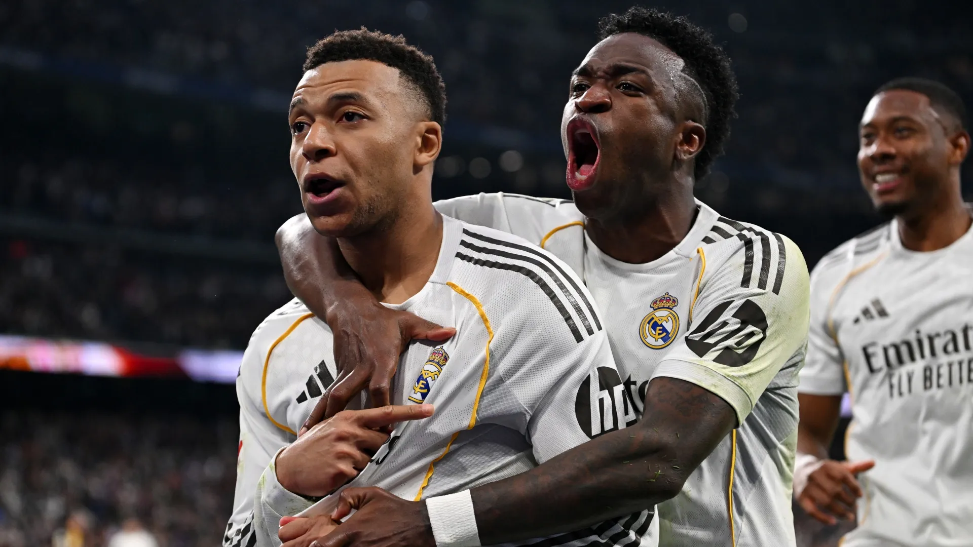 Kylian Mbappe of Real Madrid celebrates scoring with teammate Vinicius Junior.